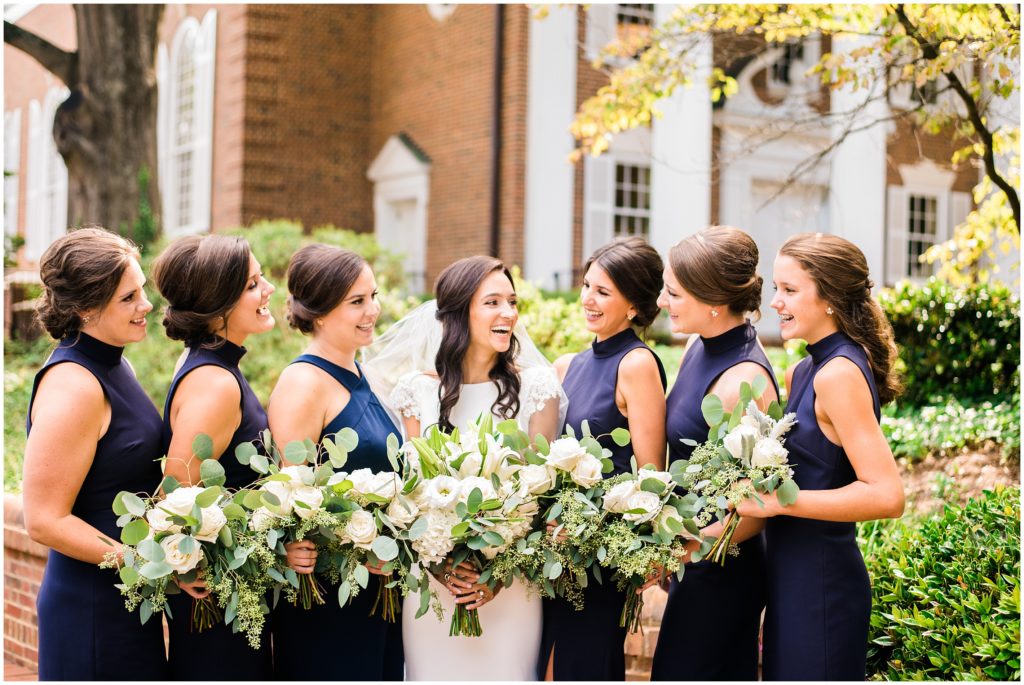 Navy Bridesmaids Dress with White Florals and Greenery Candid Raleigh Wedding Photographer