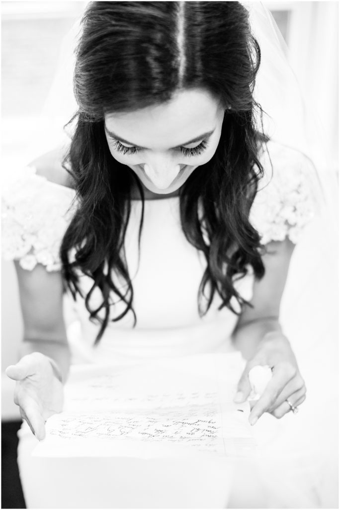 bride reading letter from groom on wedding day