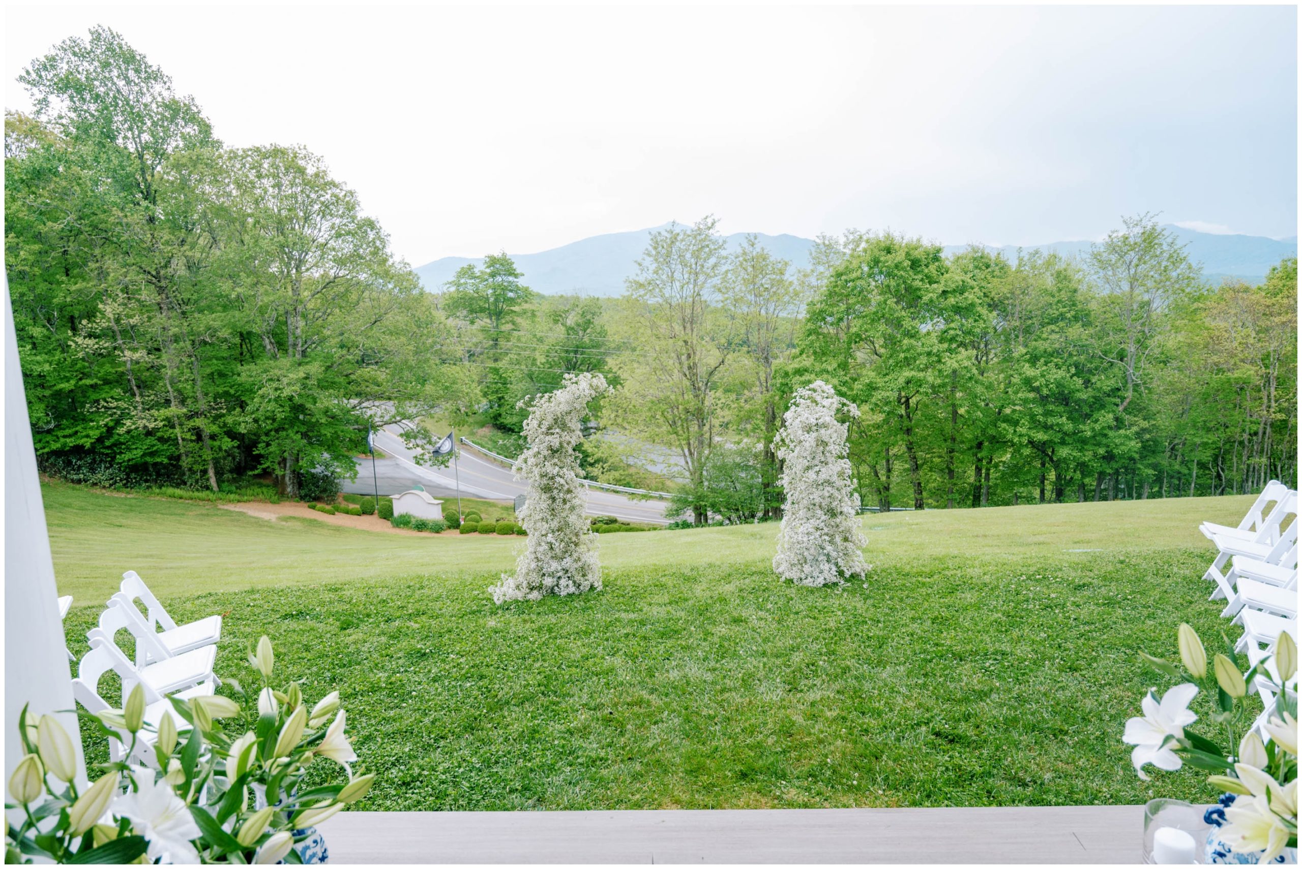 Baby's breath pillars for a spring outdoor wedding ceremony in the Blue Ridge Mountains