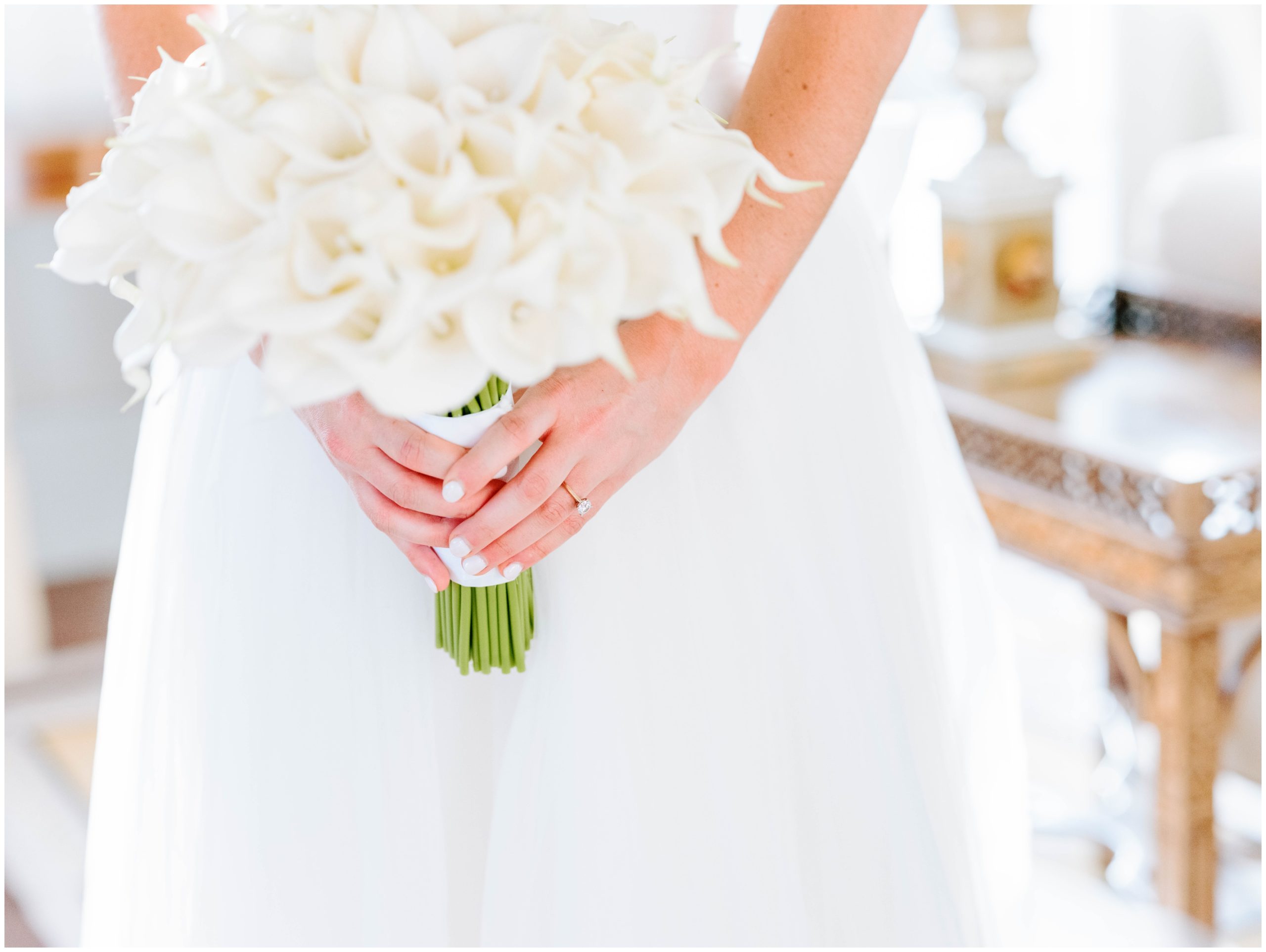 Bride holding a bouquet filled with calla lilies by Fuschia Moss