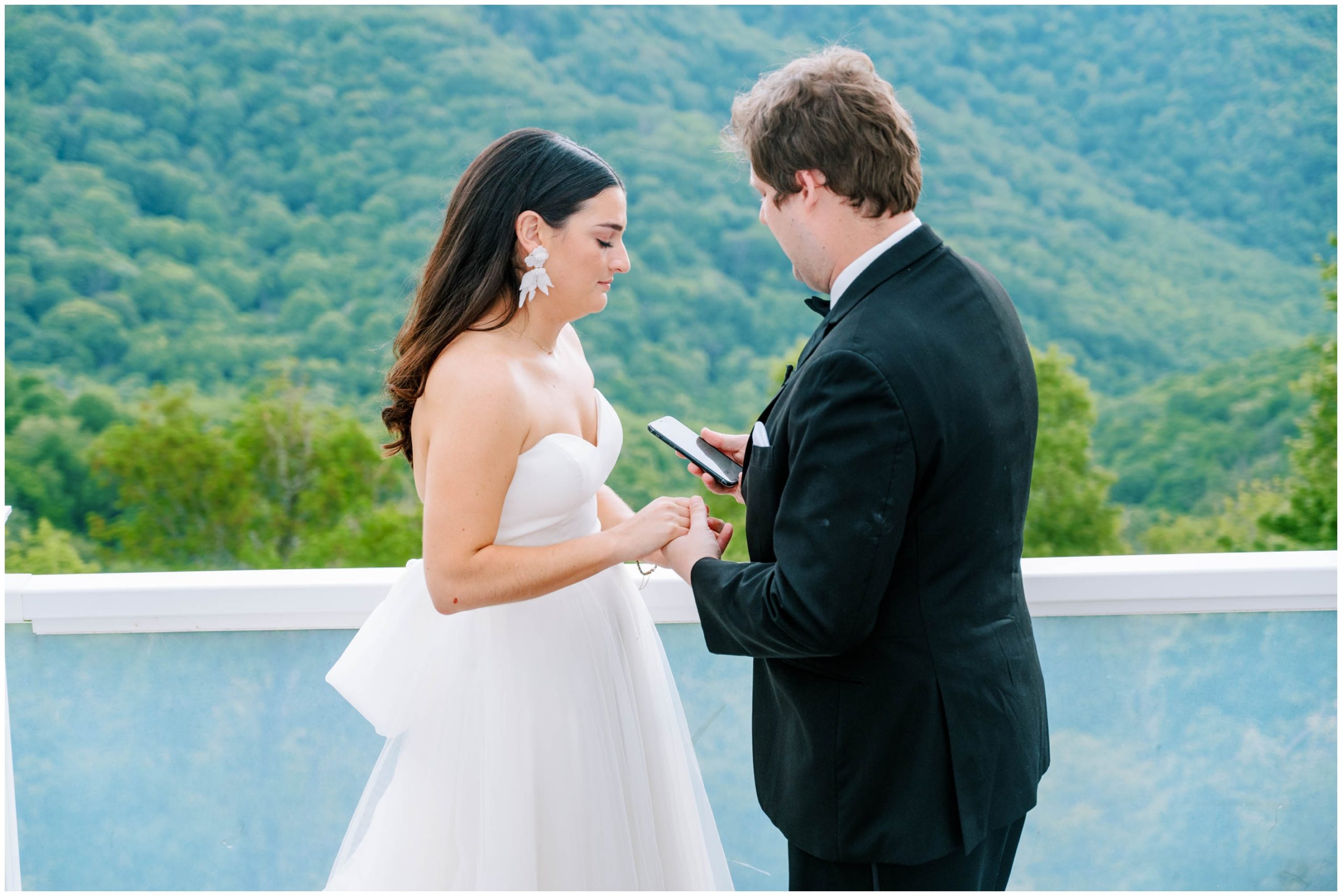 Bride and groom first look on a balcony overlooking the mountains