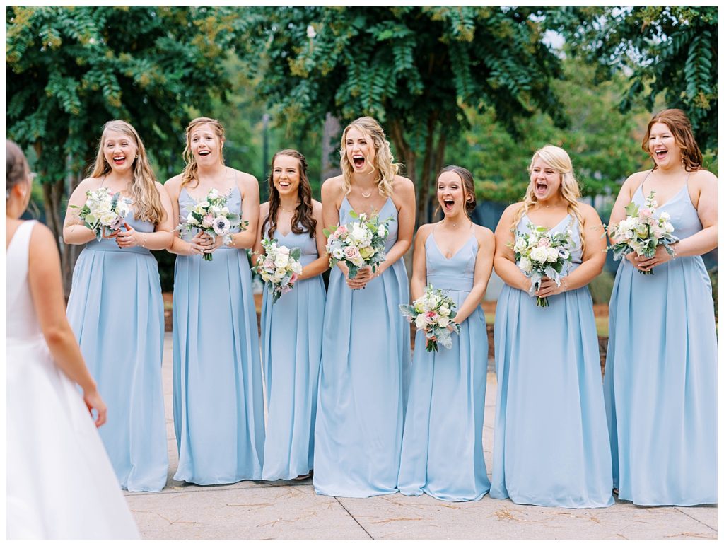 bridesmaids are so excited and shocked to see brides beauty in her dress at the chapel hill country club
