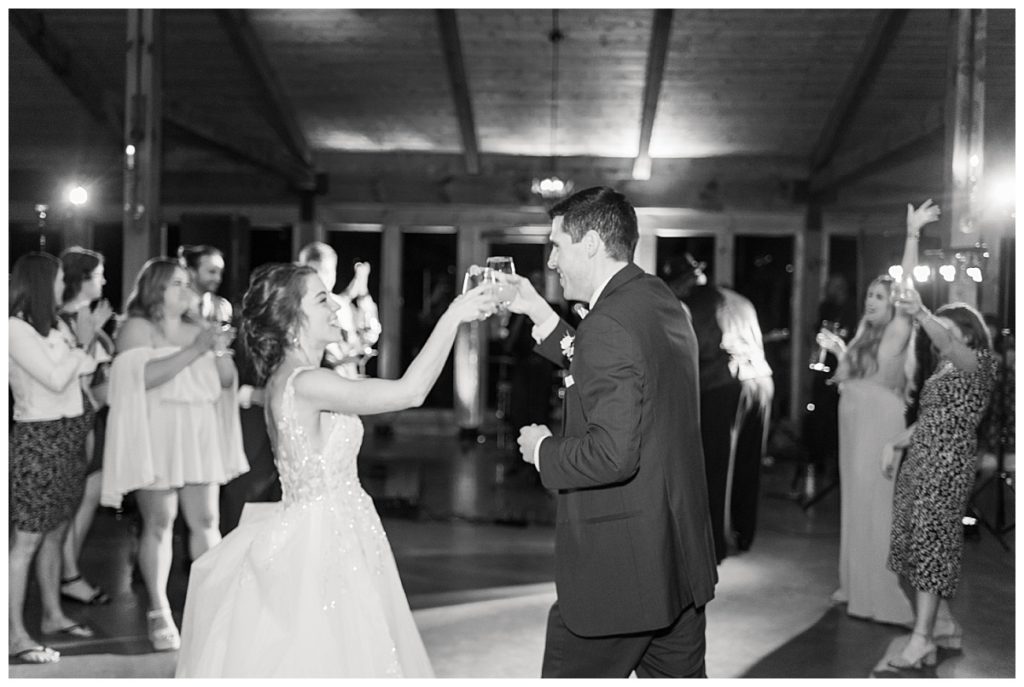bride and groom sharing a toast and cheers at The Pavillion of Carriage Farm