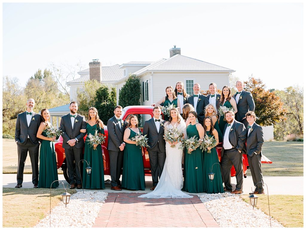 BRIDAL PARTY IN FRONT OF RED TRUCK AT THE WALNUT HILL