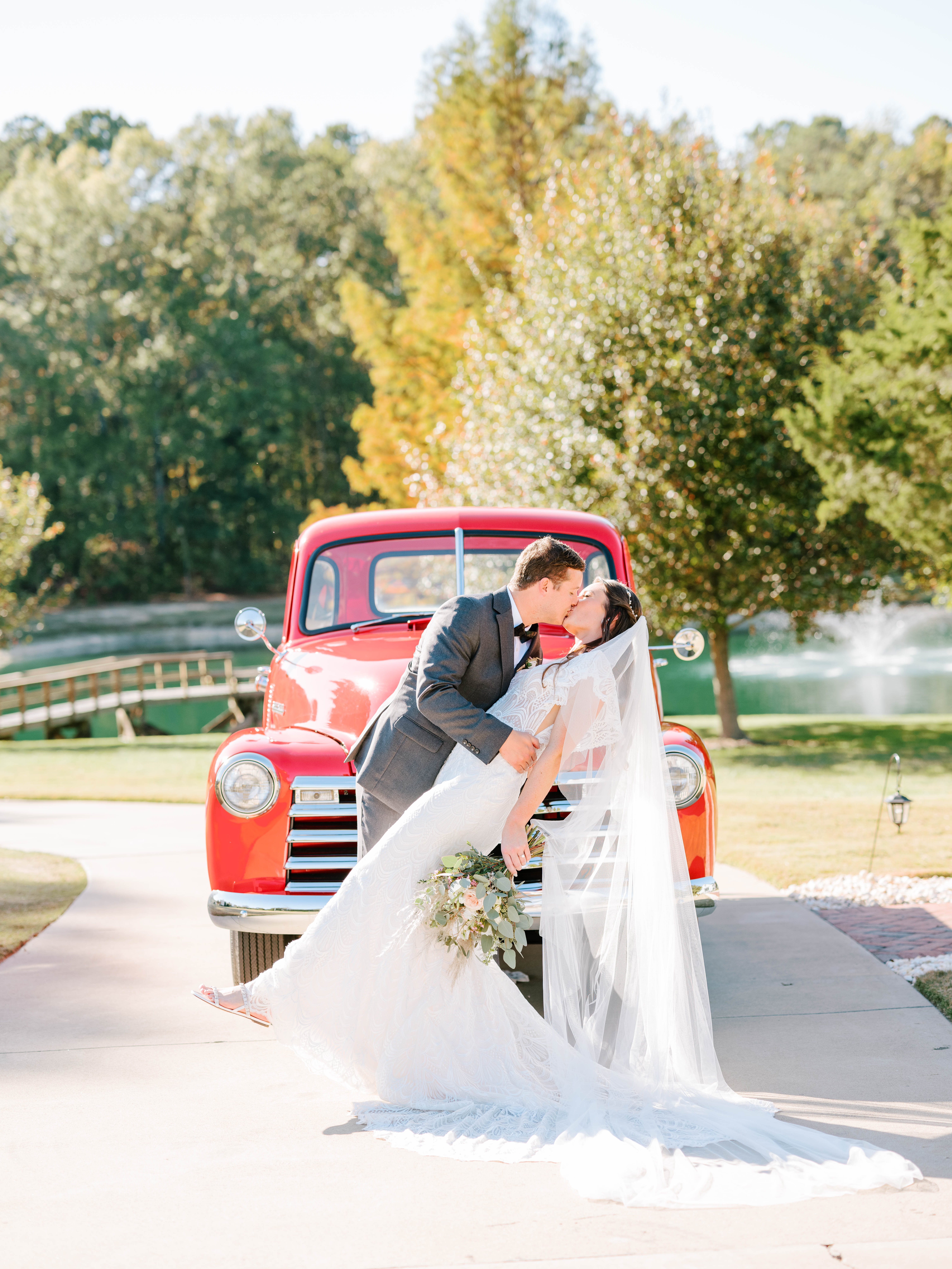 BRIDE AND GROOM IN FRONT OF VINTAGE RED CHEVY TRUCK