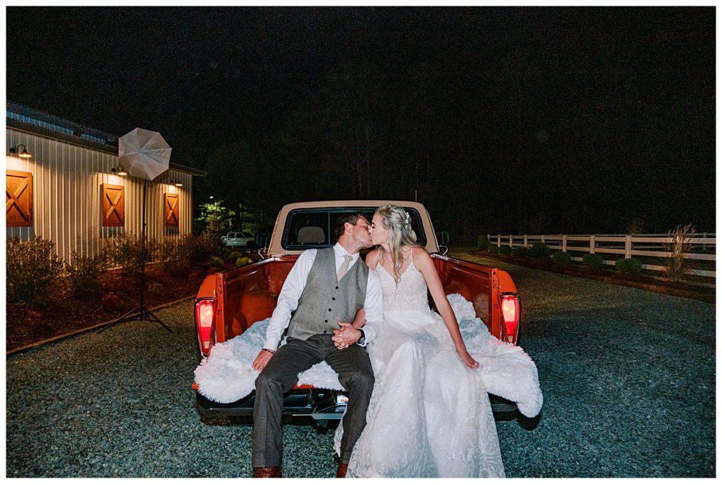 bride and groom share a kiss at the evermore farms