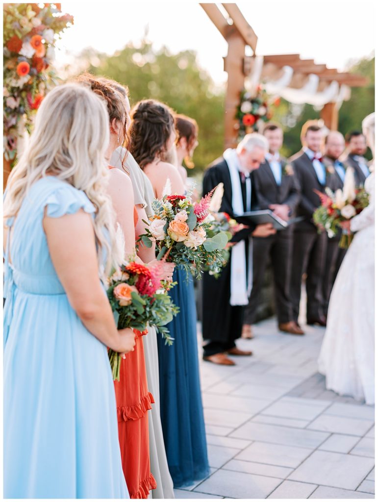 bridal party standing during ceremony at the evermore farms