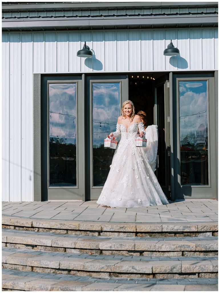 bride holding drinks at the evermore farms