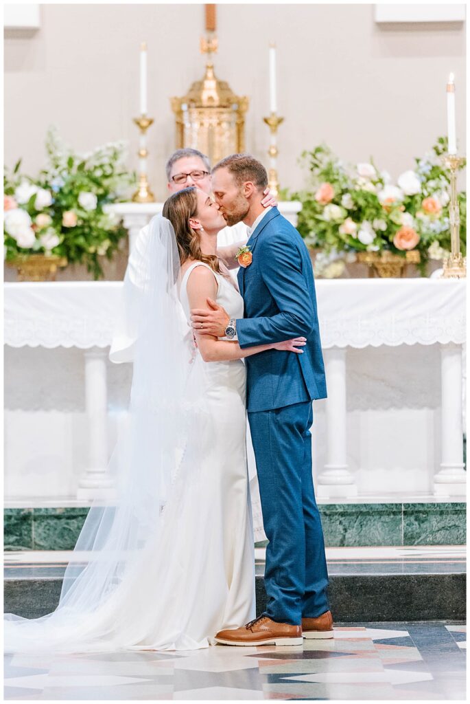 Bride and Groom first kiss at Sacred Heart Raleigh Catholic Church Wedding