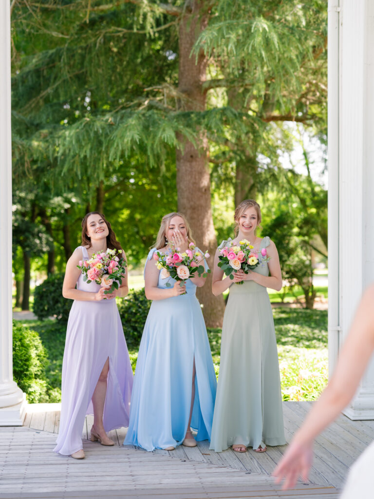 Bridesmaids in green, purple and blue for a colorful summer wedding in Raleigh, NC