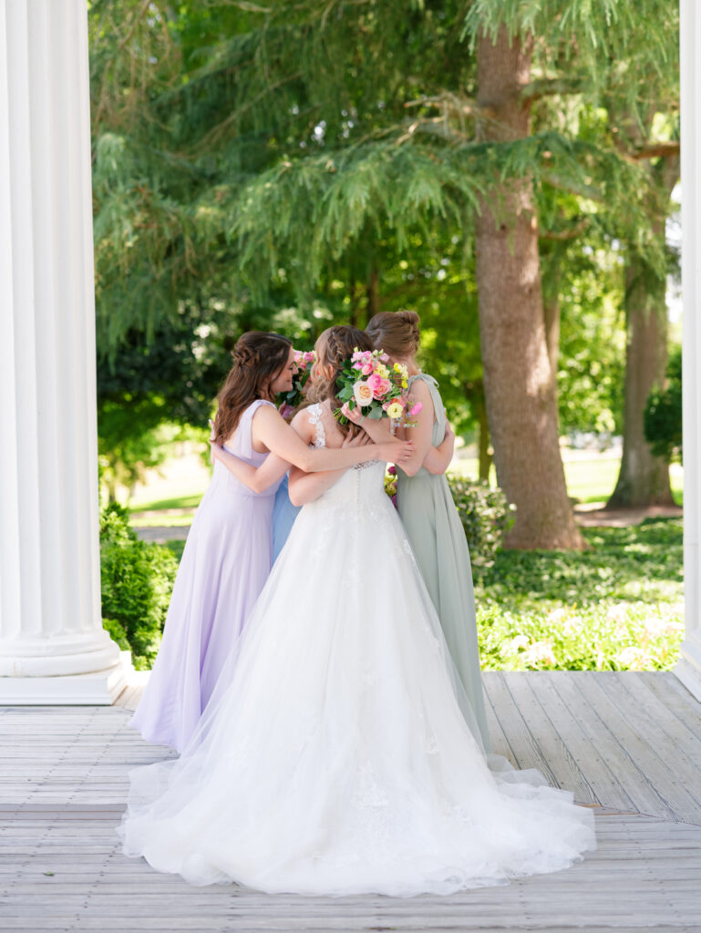 Bride and bridesmaids hugging at Rose Hill Estate Raleigh Wedding Photographer