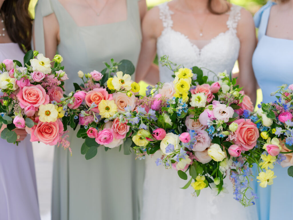 beautiful pink, yellow, coral, purple bride and bridesmaids bouquets by Expression of Love Florist in North Carolina