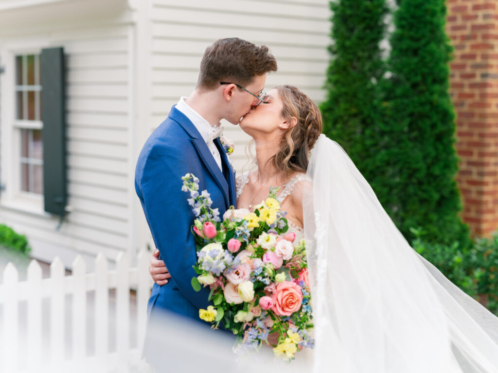 Bride and Groom kiss with the veil sweeping around them at Rose Hill Estate