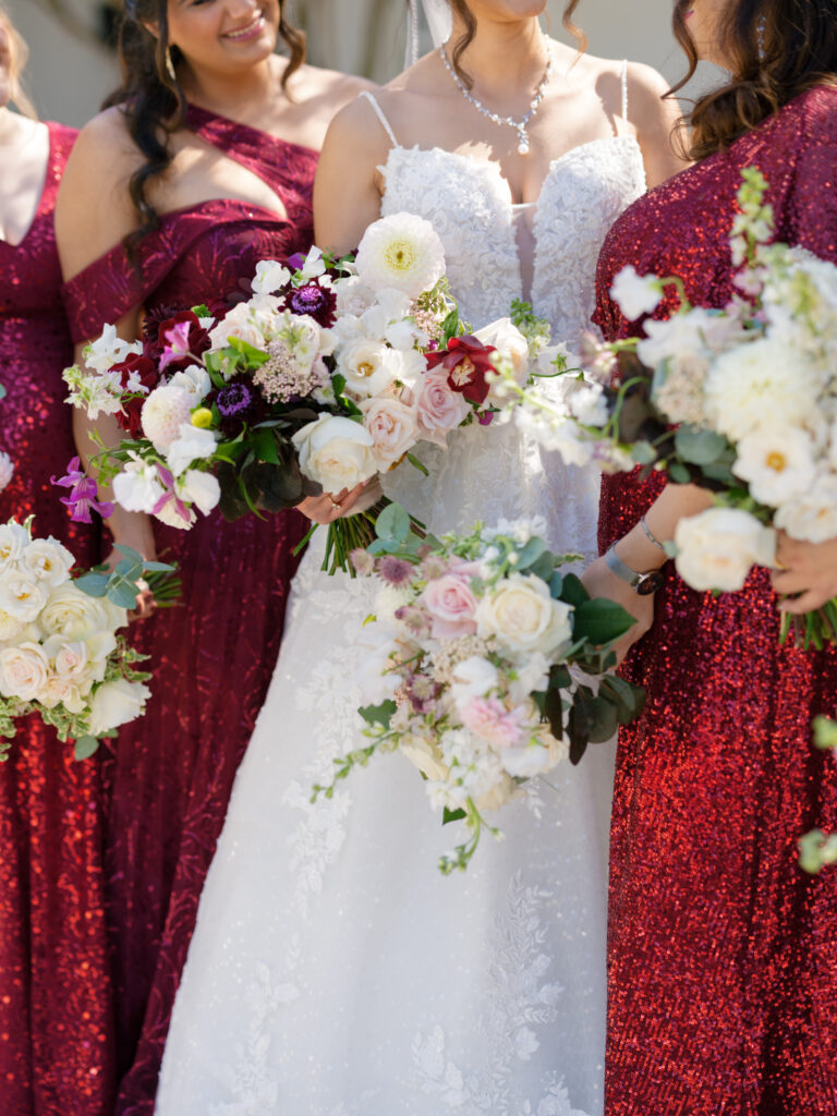 Bride and bridesmaids holding bouquets outside at donovan's manor in north carolina