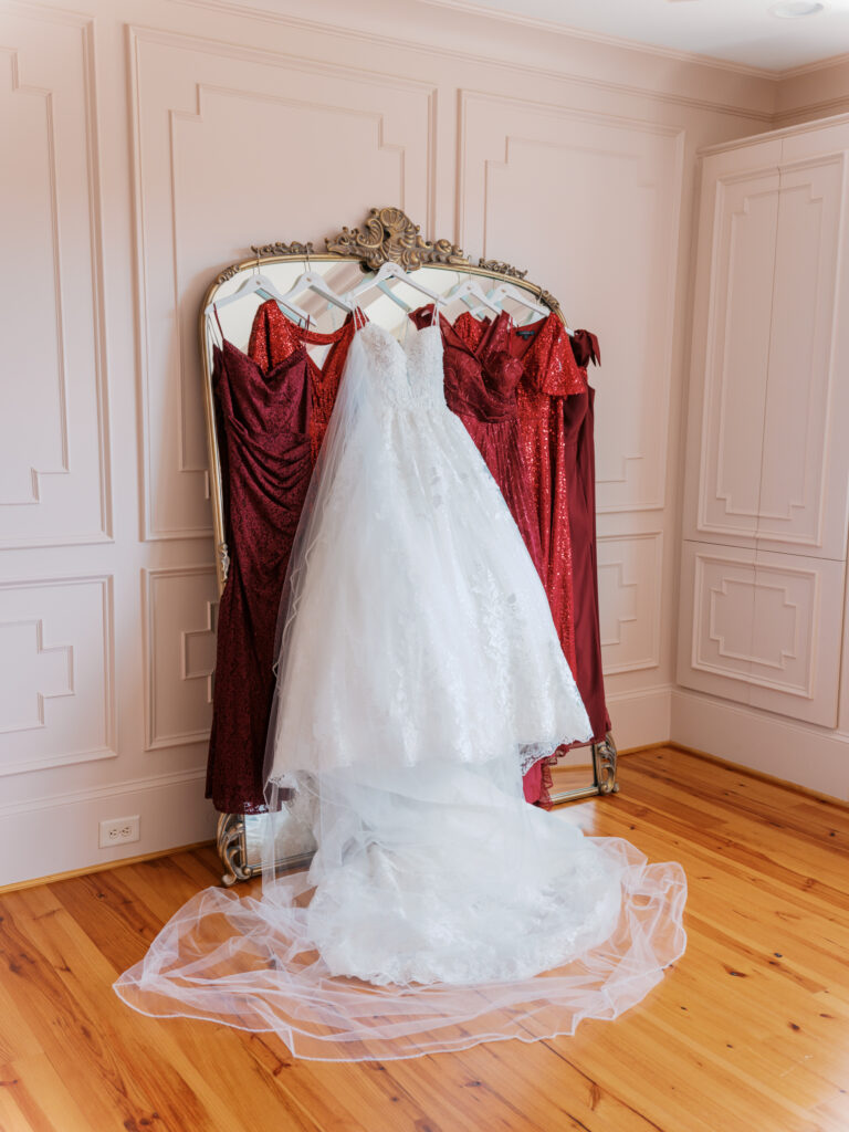 bride and red sequin bridesmaids dresses hung up on the mirror in the bridal suite of Donovan's Manor