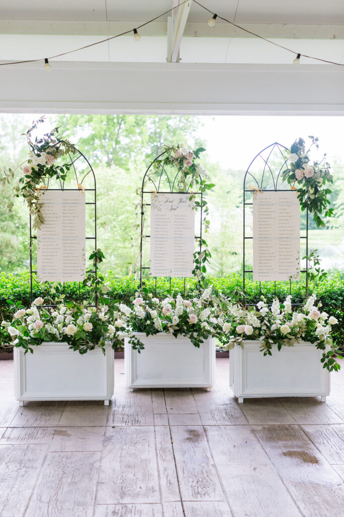 garden planters turned into overflowing flowers for a seating chart for guest at a wedding in Raleigh NC Florals by Once Gathered, Rental from Greenhouse Picker Sister